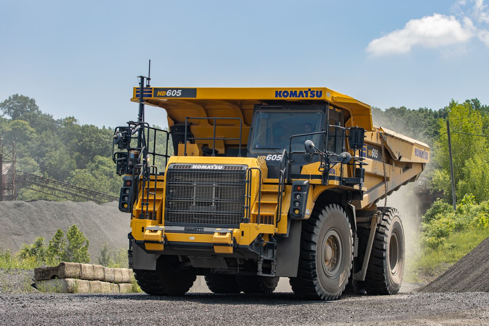 Komatsu HD605 rigid haul truck on a quarry haul road